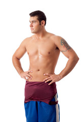 Fototapeta premium Young adult male wrestler. Studio shot over white.