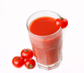 Fresh tomatoes and a glass full of tomato juice