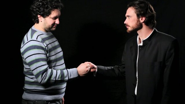 Two men playing paper rock scissors