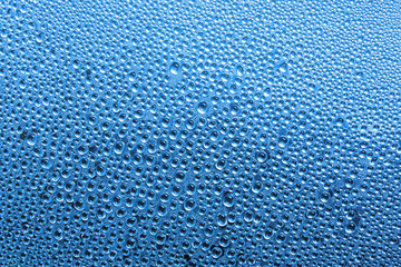 Water drop on glass in Blue