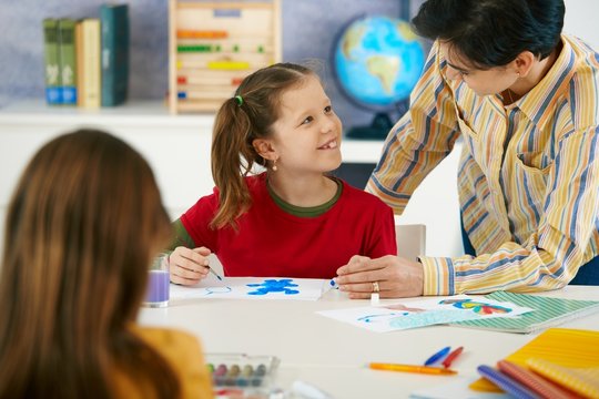School children and teacher in art class