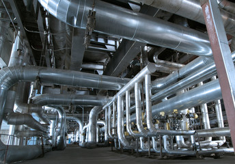 Equipment, cables and piping as found inside of a modern industr
