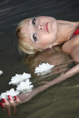 Fototapeta premium blond woman lying in water