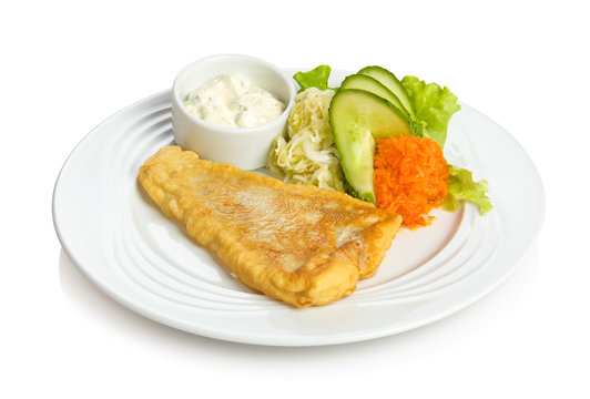 Fried fish with sauce and vegetable side dish