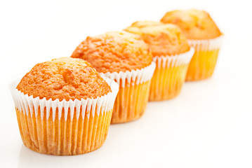 Fresh baked cupcakes over white. Shallow depth of field