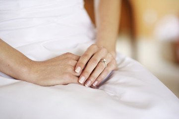 Fototapeta na wymiar Beautiful woman's hands on a white dress