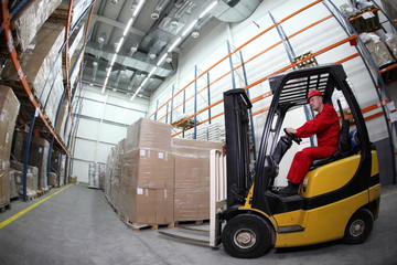 forklift operator at work in warehouse
