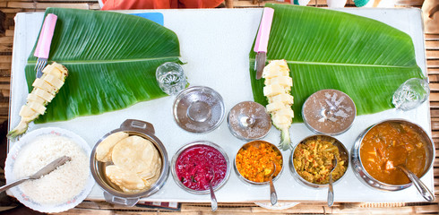 Fototapeta na wymiar Traditional Indian meal serve on banana leaves