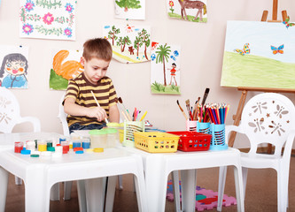 Child paint picture in preschool.