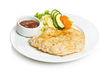 Pork chop with tomato sauce and vegetable side dish
