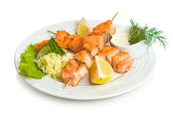 Salmon kebab with sauce and vegetable side dish