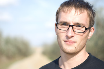 Young handsome serious man in glasses