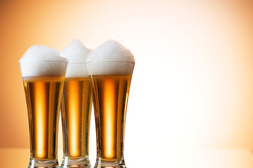 Beer glasses against the colorful gradient background
