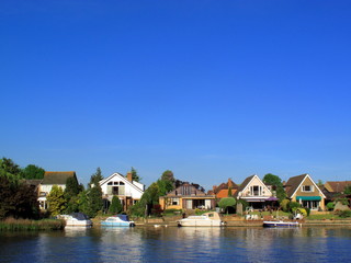 Homes and moored boats on the River Thames at Windsor
