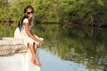 Beautiful woman relaxing outdoors by the lake
