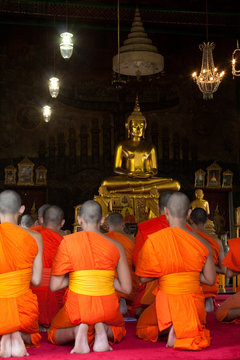 Buddhist Monks Praying In Temple