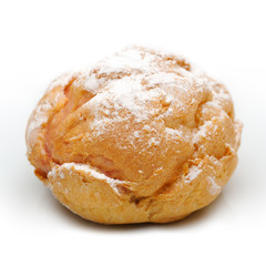 Single profiterole on a plate, isolated, white background