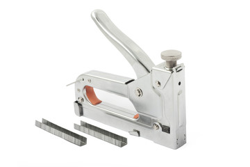 Building stapler and clips on white - obrazy, fototapety, plakaty