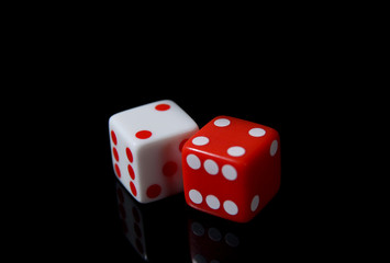 a pair of white and red dice on a black background