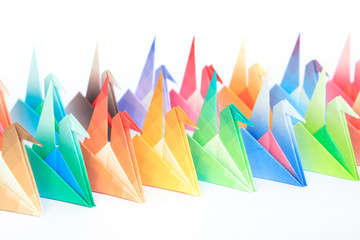 2 rows of colourful origami birds. Shallow depth of field.
