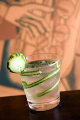 Wodka passion cocktail with slices of cucumber
