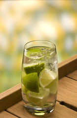 Caipirinha cocktail with pieces of lemo
