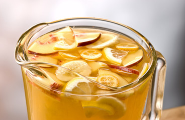 blanca sangria with pieces of apple, banana, oranges and lemon