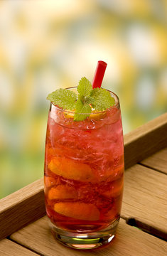 brazilien crush cocktail with a red straw and mint