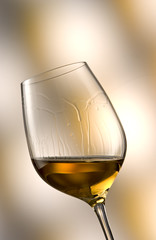 Glass of white wine in yellow-brown ambiance