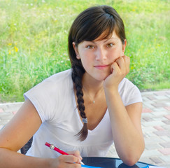 Young woman doing her homework at a table