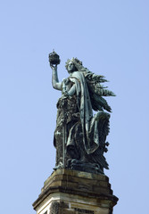Old Angel monument in front of clear sky.