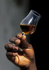 Hand with a glass of whiskey