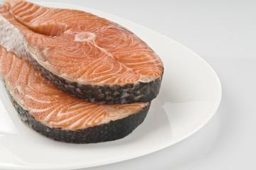 Salmon raw steak on white plate