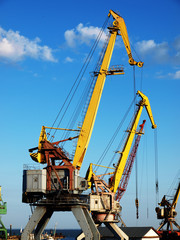 Fototapeta na wymiar Marine cranes in cargo port closeup