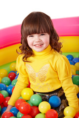 Fototapeta na wymiar Happy child in group colourful ball.