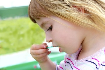 blond little girl eating ice cream portrait