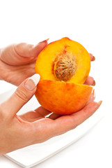 Peach in female hands