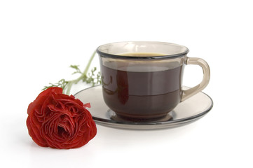 A cup of coffee and red flower