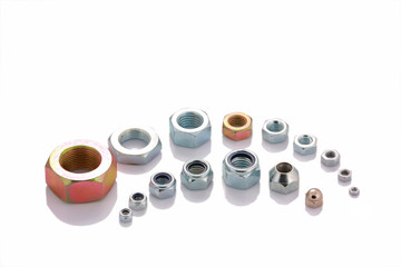 Varied steel nuts isolated on white background with copyspace