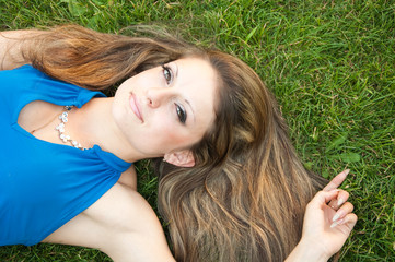 Young woman lying on the grass