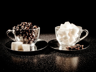Two cups with coffee beans and sugar