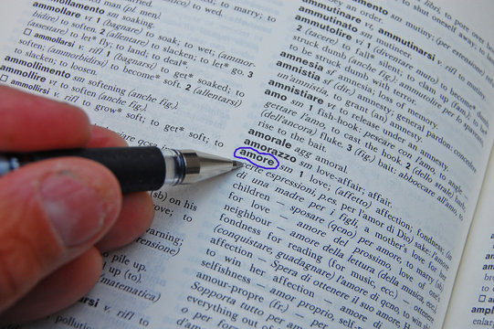 That's amore or What love is - Looking up the meaning of the word AMORE in a dictionary and circling it with a pen 