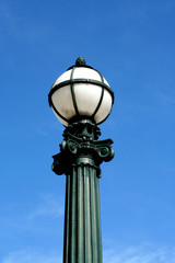 Fototapeta na wymiar Old streetlight against blue sky