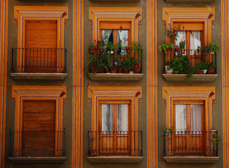 Colorful balconies and windows in streets of Granada