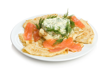 Russian pancakes with salmon and salad