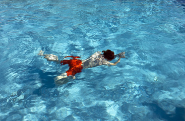 happy child is swimming in the pool