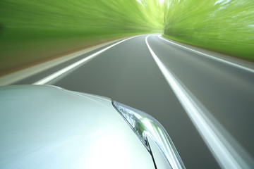 Fototapeta premium car driving fast into forest