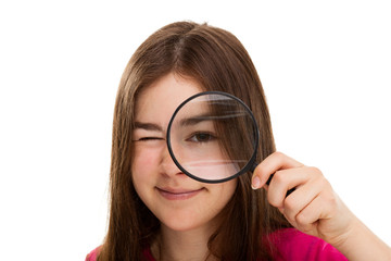 Girl holding magnifying glass isolated on white