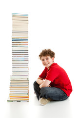 Student sitting close to pile of books on white