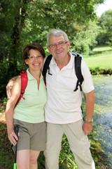 Senior couple on a rambling day by a river